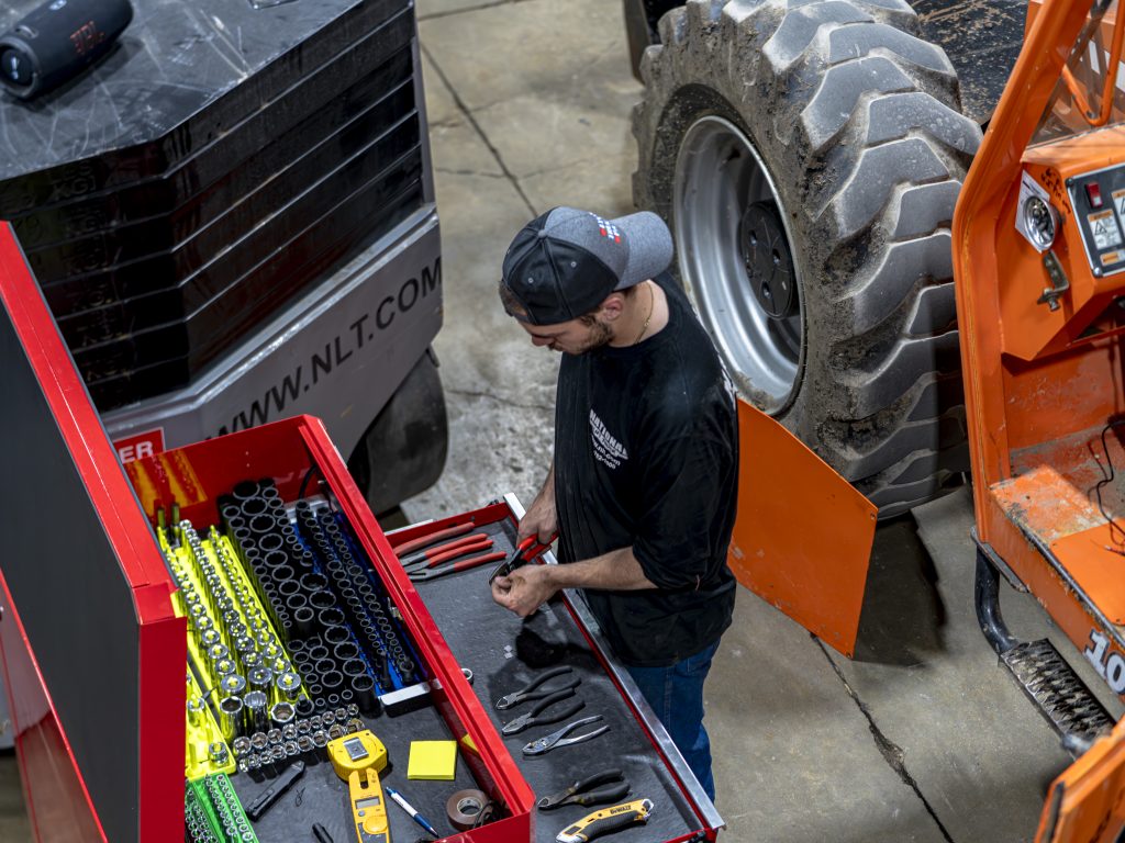 Service technician performing equipment repairs on forklift and aerial lift equipment at National Lift Truck in Chicago, Memphis, and Little Rock