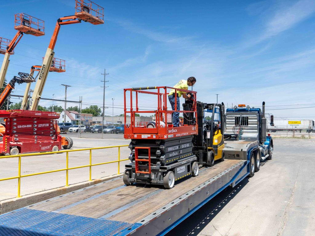 equipment being loaded onto a trailer - National Specialized Hauling in Chicago